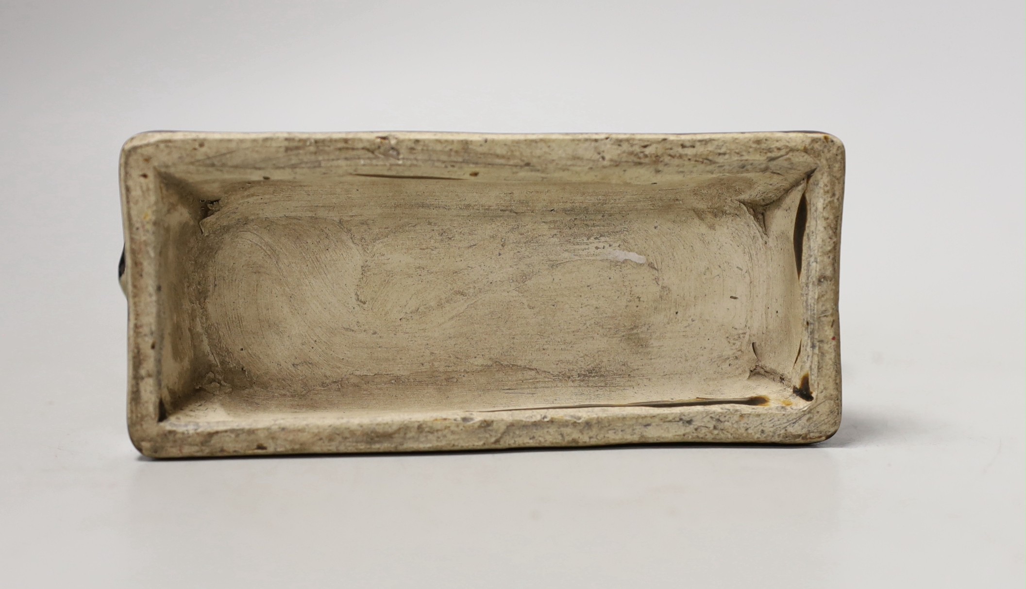 A Chinese Cizhou style pottery ‘tiger’ incense stick holder on wood stand, 13cm tall